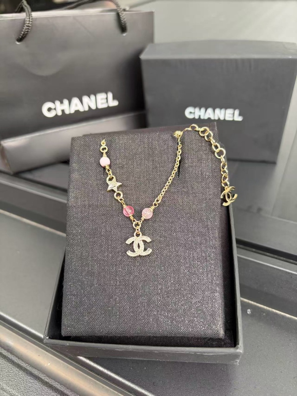Gold-Tone Bracelet with Pink Beads and CC Charm Adjust Approx:7.2-8.5”